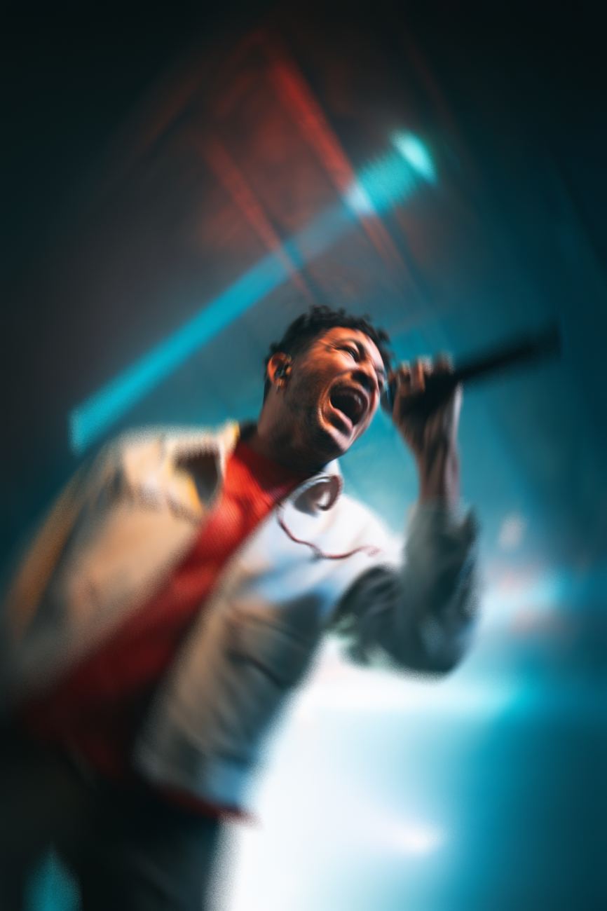 a singer mid-note with drift trails off the mic