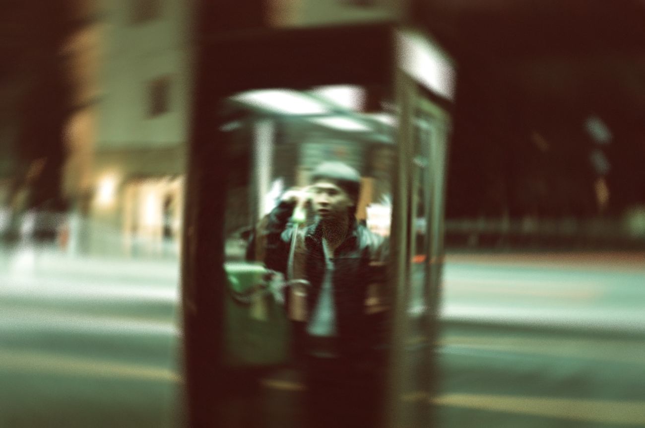 a phone booth doubled in drift reflections
