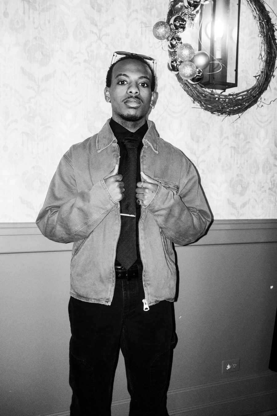 guest adjusting the collar of a suede jacket