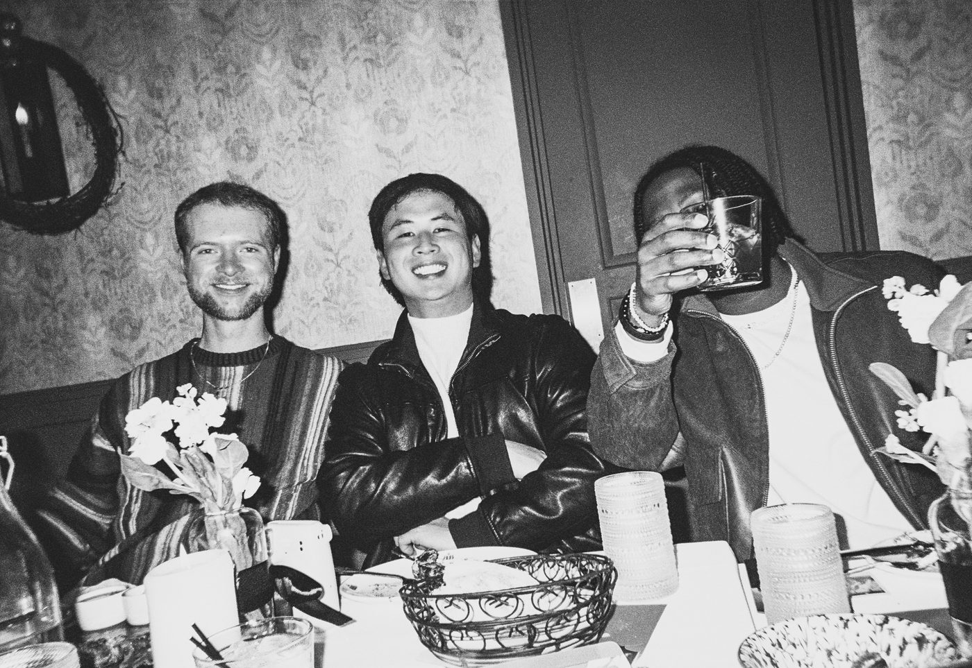 three guests raising a glass at the table