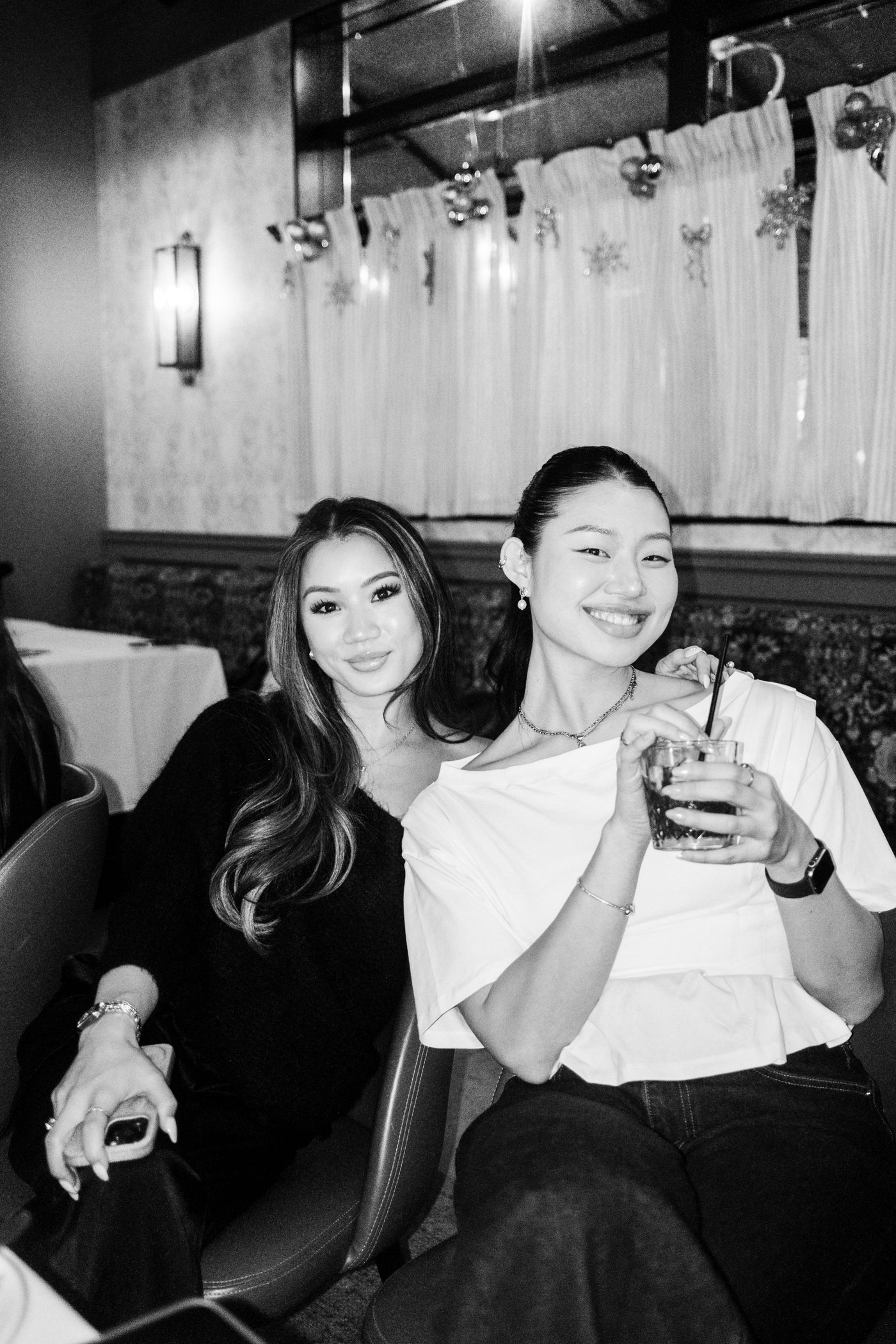 two guests sharing a drink and a look at the table