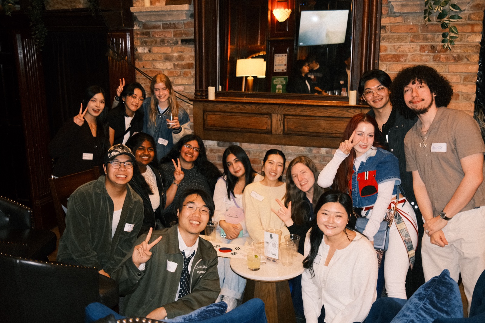 thirteen strangers around one table at vol 1, all peace signs