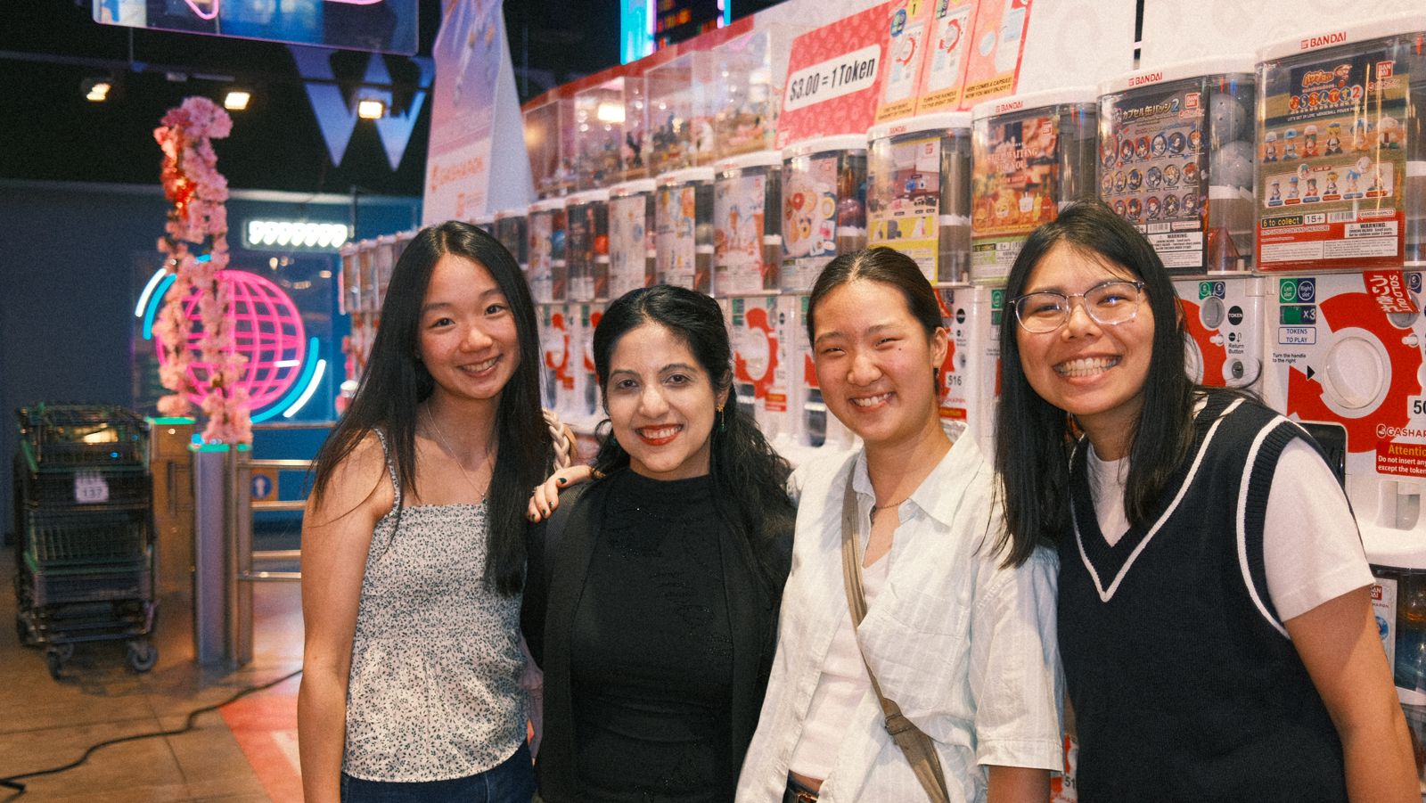 four friends in front of the gachapon wall
