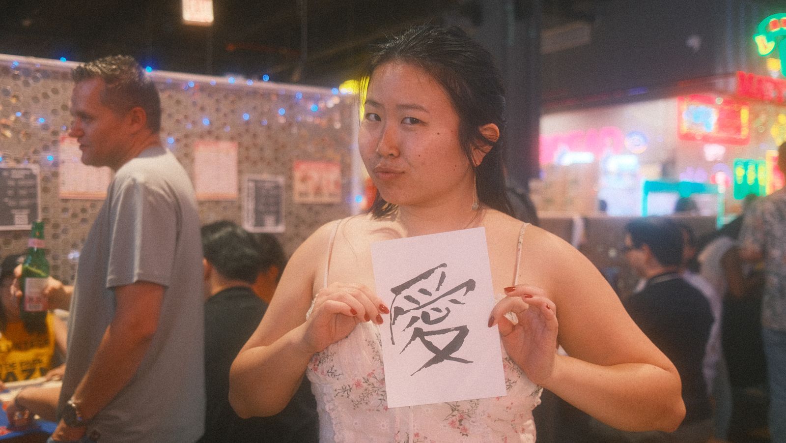 a guest showing the 愛 love calligraphy card she just made