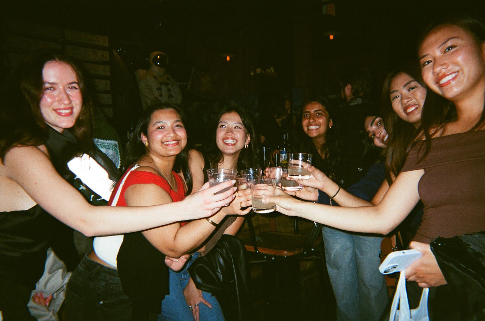 seven glasses meeting in the middle at arcade-bar night