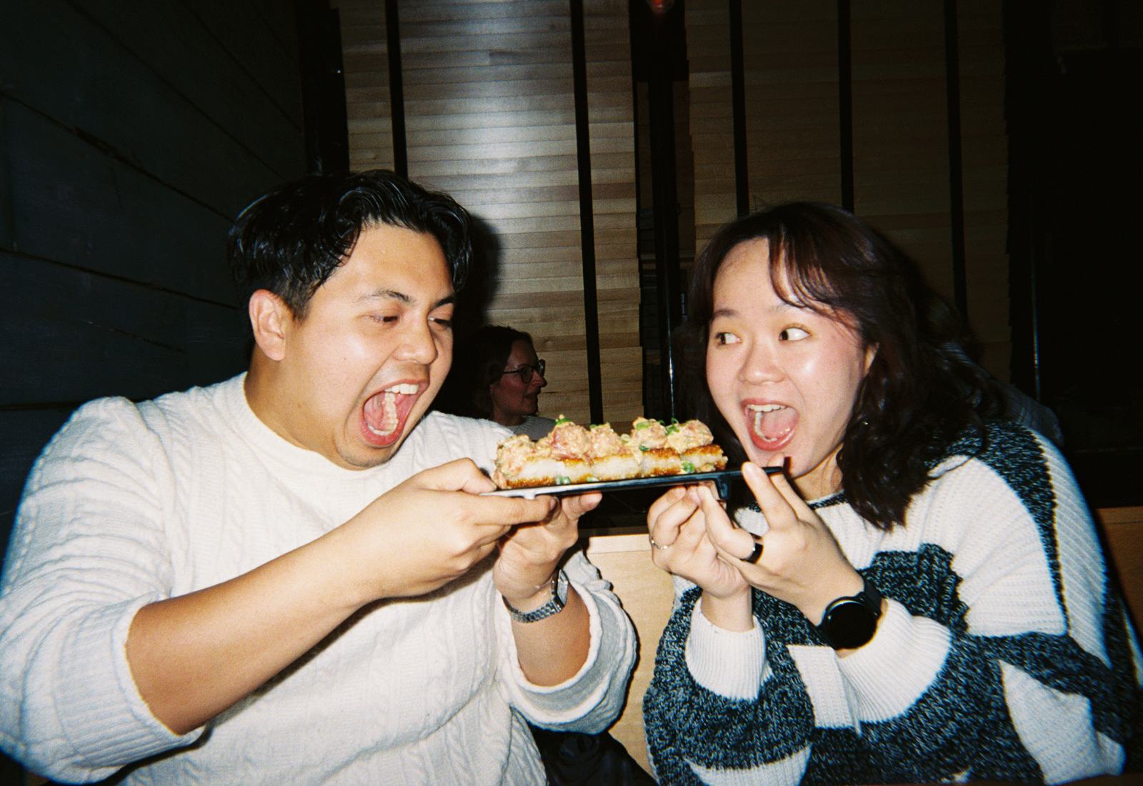 one member feeding another sushi at the dinner lounge — experience 6