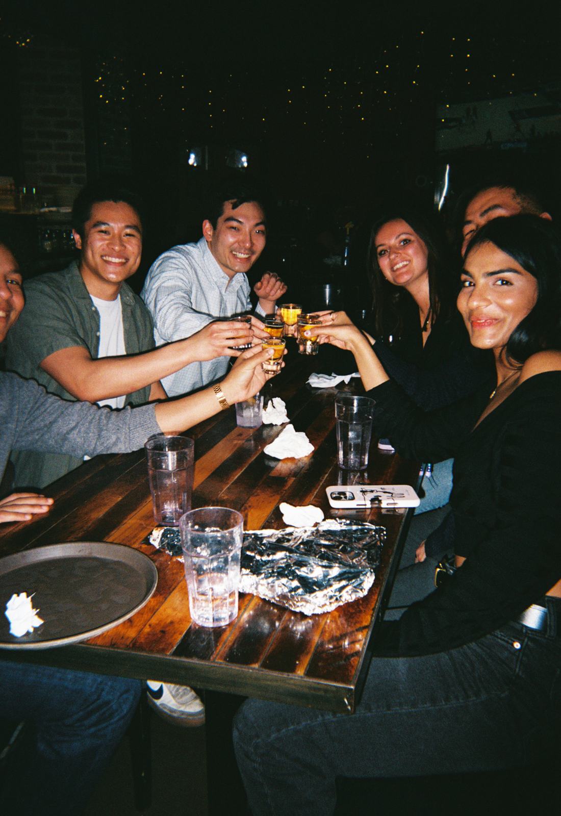 glasses raised over the dinner table — experience 5